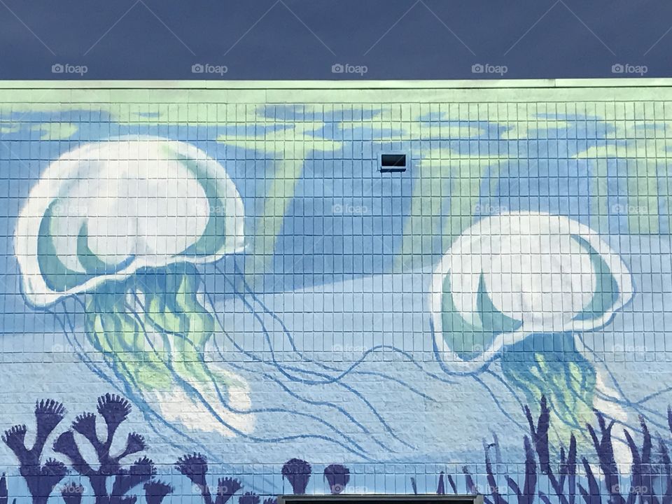Jellyfish painted on the side of a building.