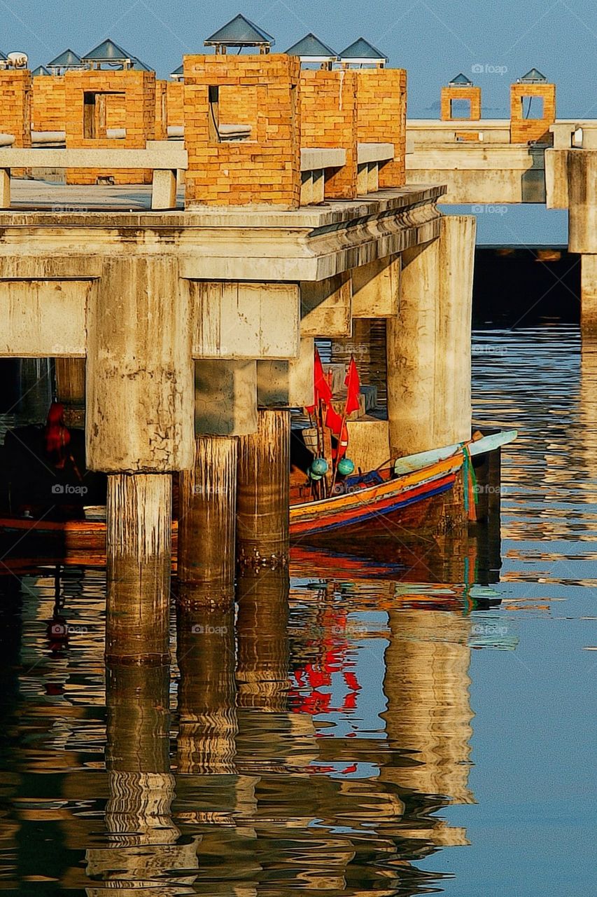 Boat under pier in lake