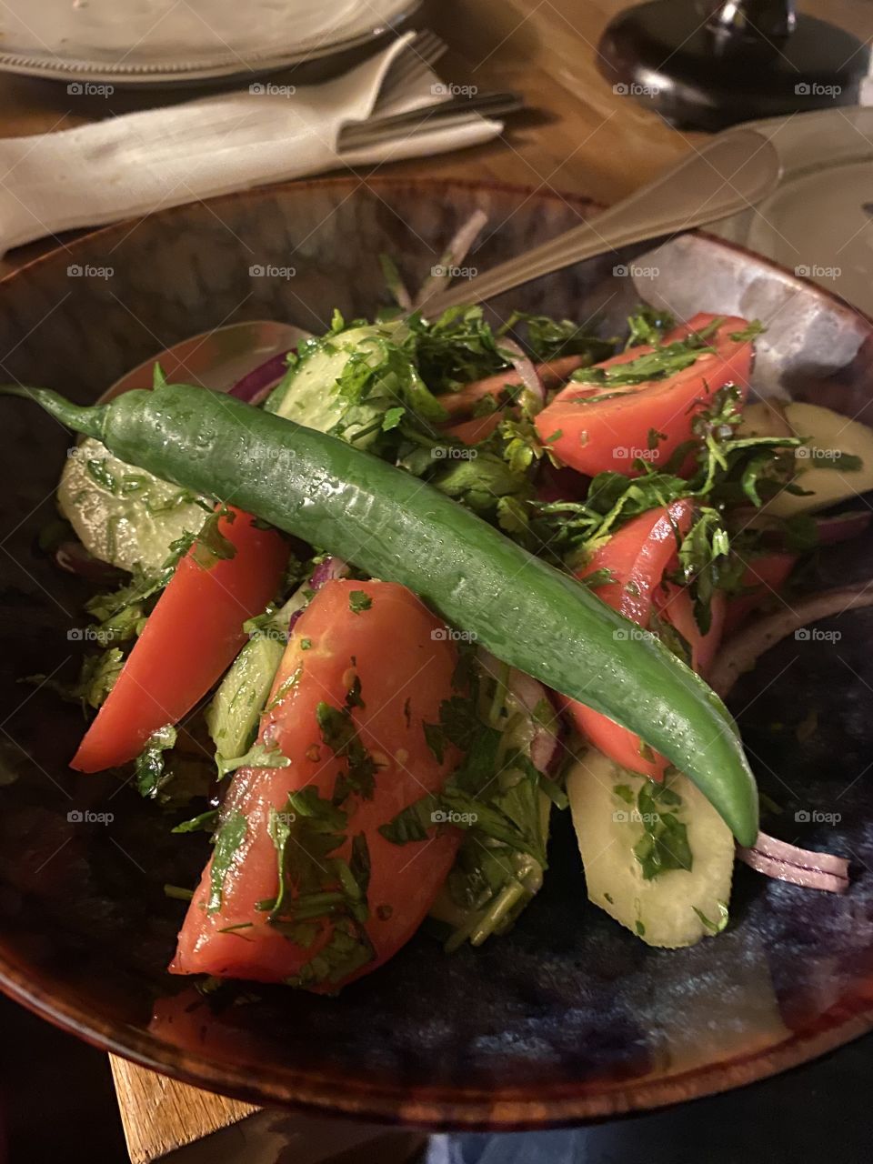 Traditional Georgian Tomato and cucumber salad with a pepper