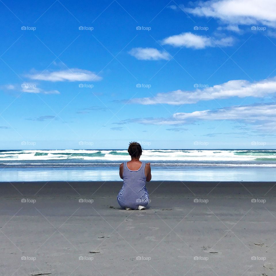 Girl contemplating ocean 