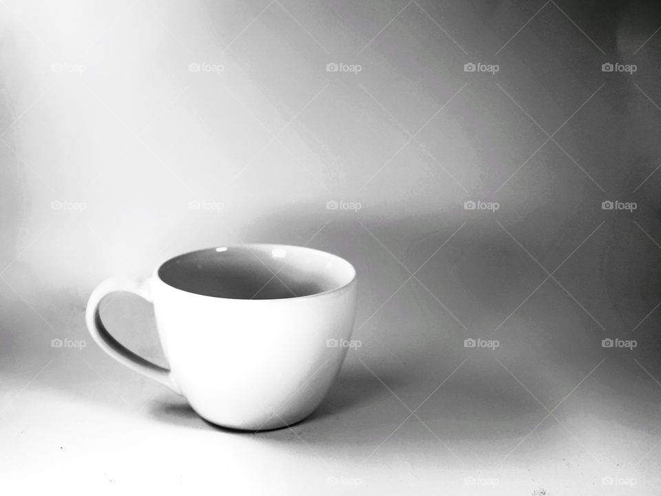 Blank coffee cup on the shadow background