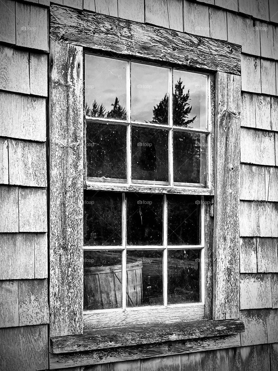 “Forgotten Basket.”  A basket sits near the window sill of an old shingled farm house.