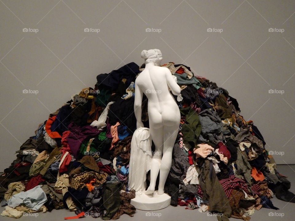 art exhibit statue who needs to do laundry there are many clothes please someone clean them