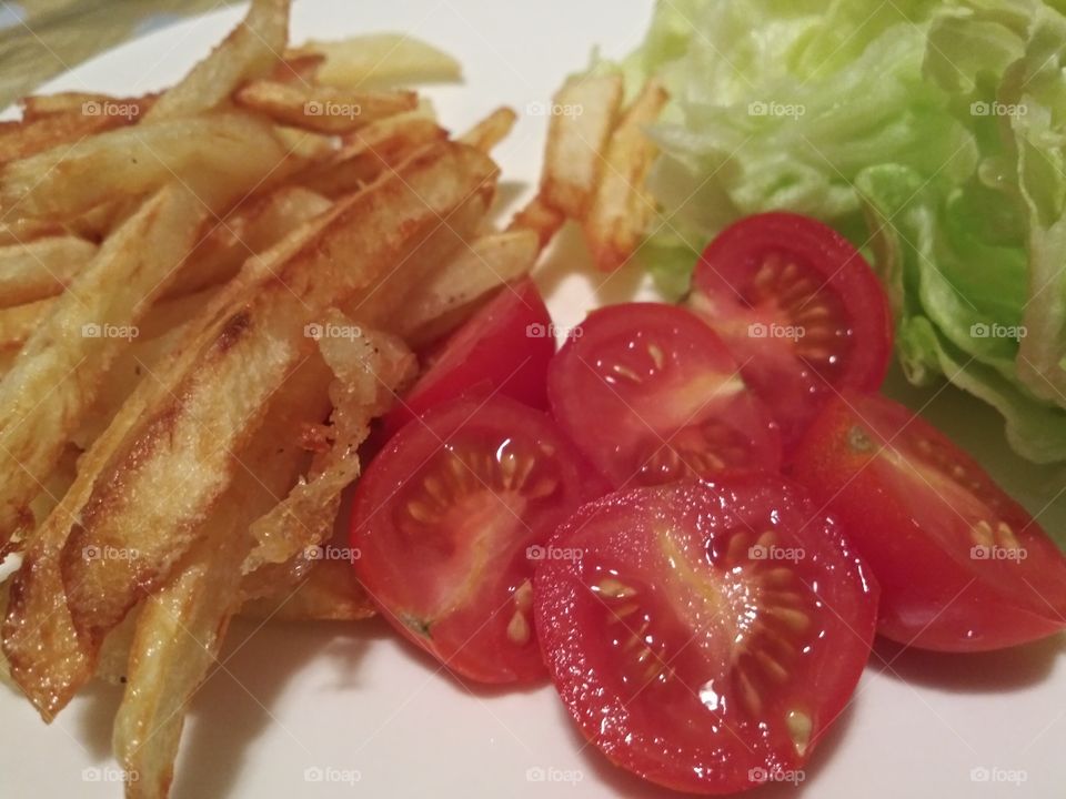 frech fries tomatoes slices and lettuce