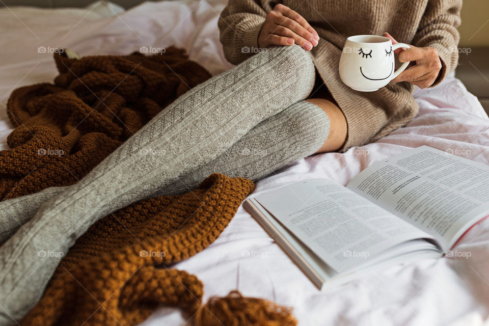 Woman reading book at home