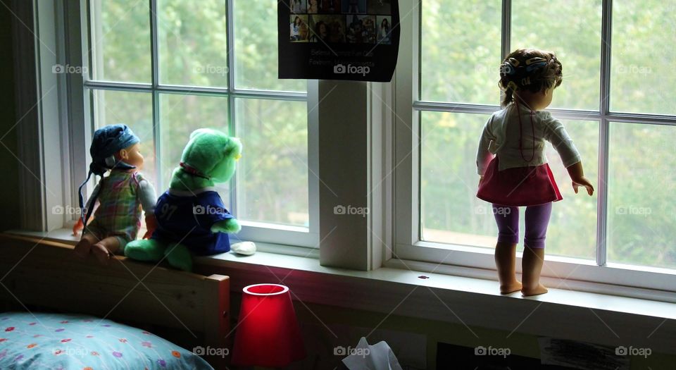 Keeping watch . My daughter set up her dolls to look out the window  - they scared me to death when I walked into her room!