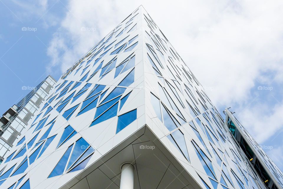 Modern architecture, looking up on modern office building with different geometrical window shapes, Oslo Norway 