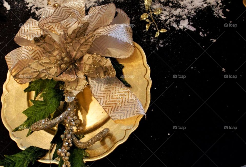 Gold and black table scape . A golden plate on a black tablecloth 