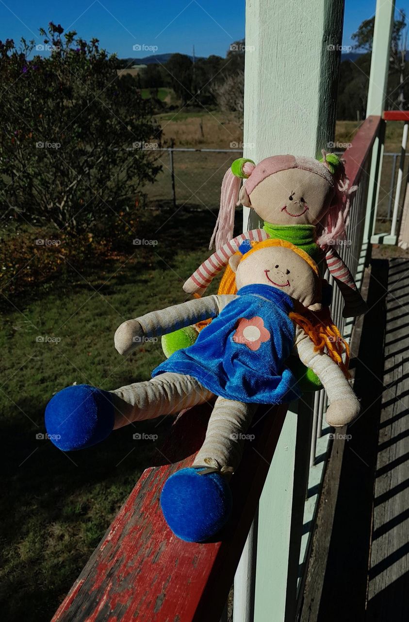 Dolls on Verandah Rail