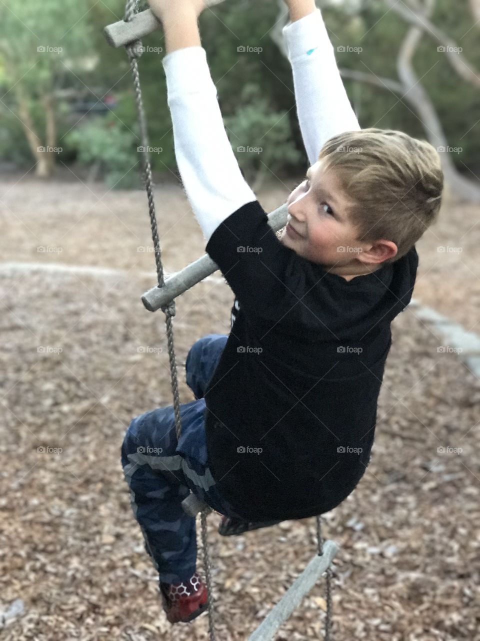 Boy on rope ladder swing