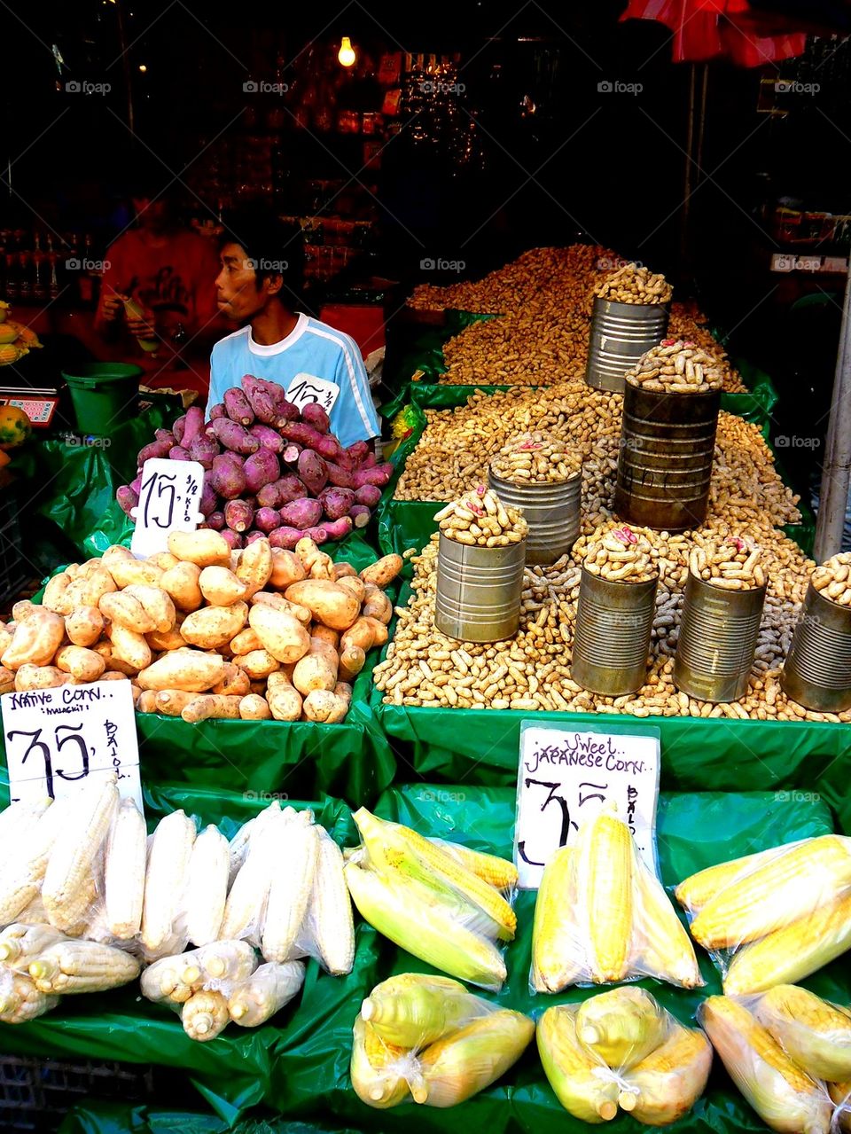 asian street vendor selling raw peanuts, corn and other food items in quiapo, manila, philippines in asia