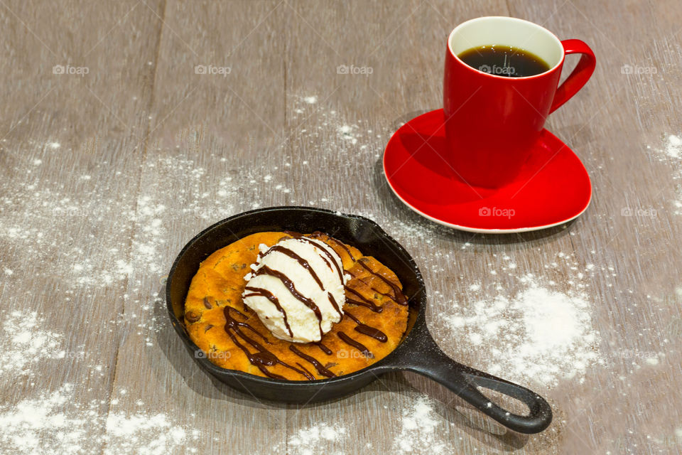 Ice Cream Dessert in Skillet With Cup of Coffee