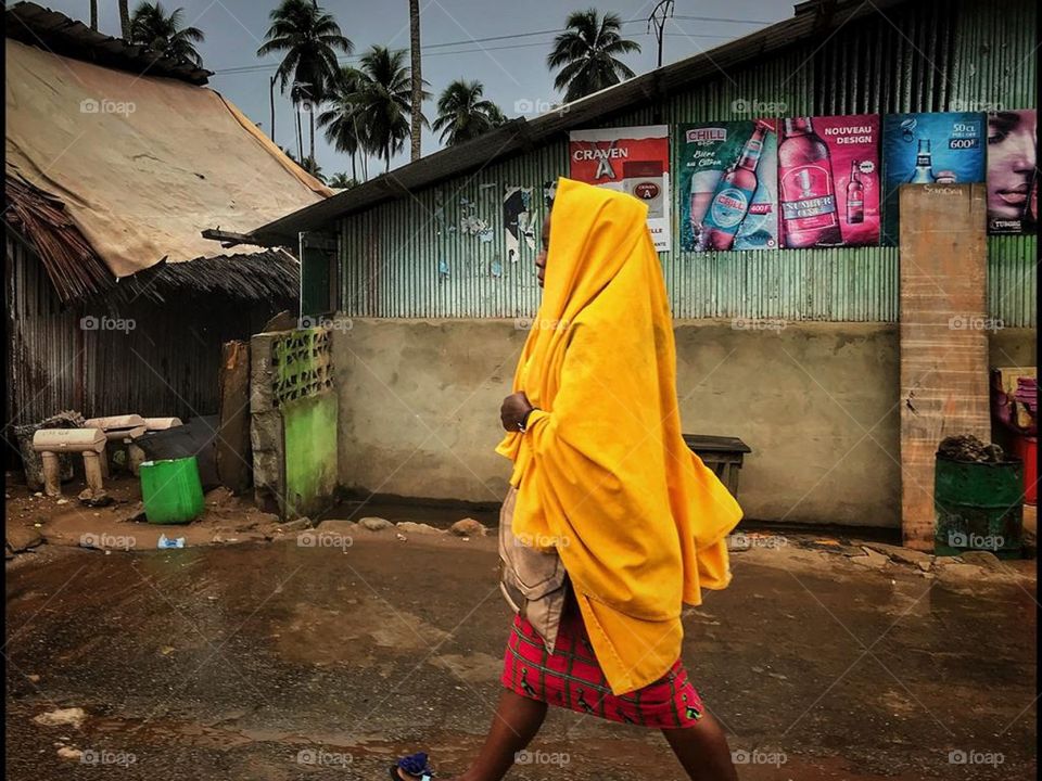 Young lady walking down Abidjan streets, Africa.