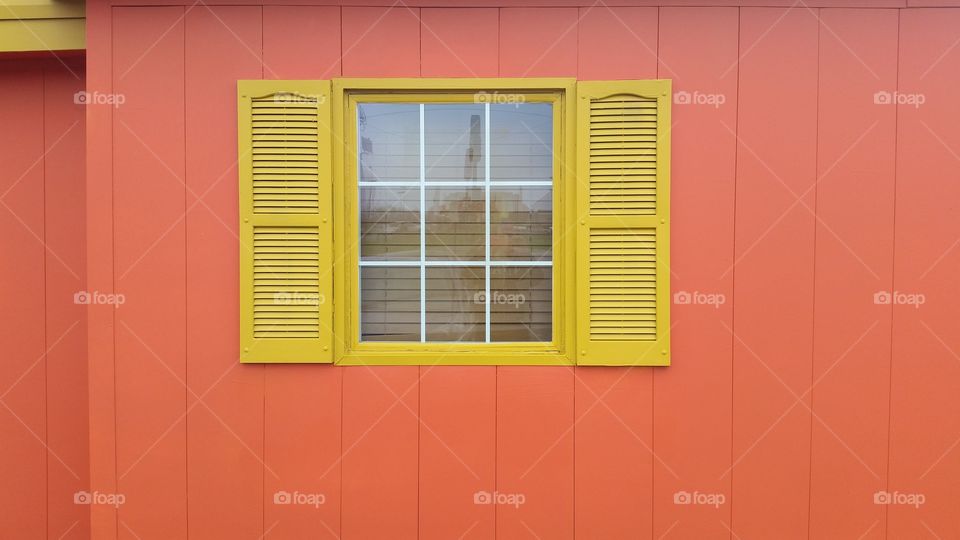 Orange building exterior and yellow window