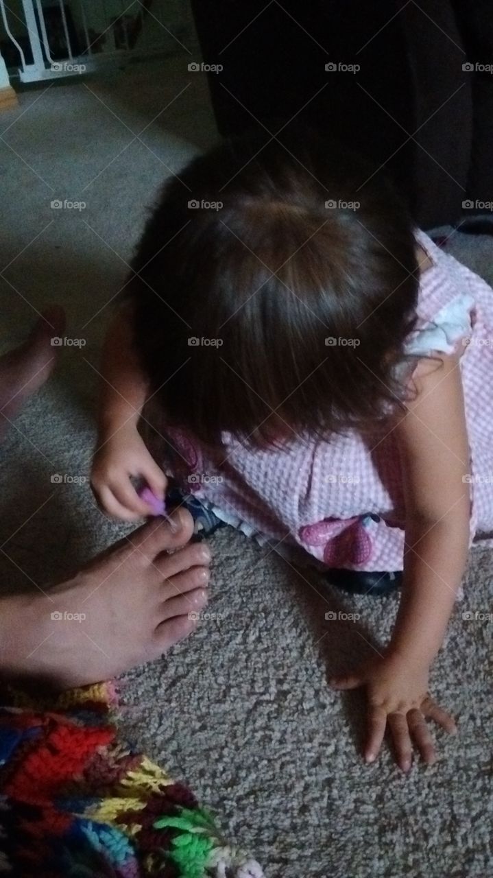 toddler girl painting toe nails