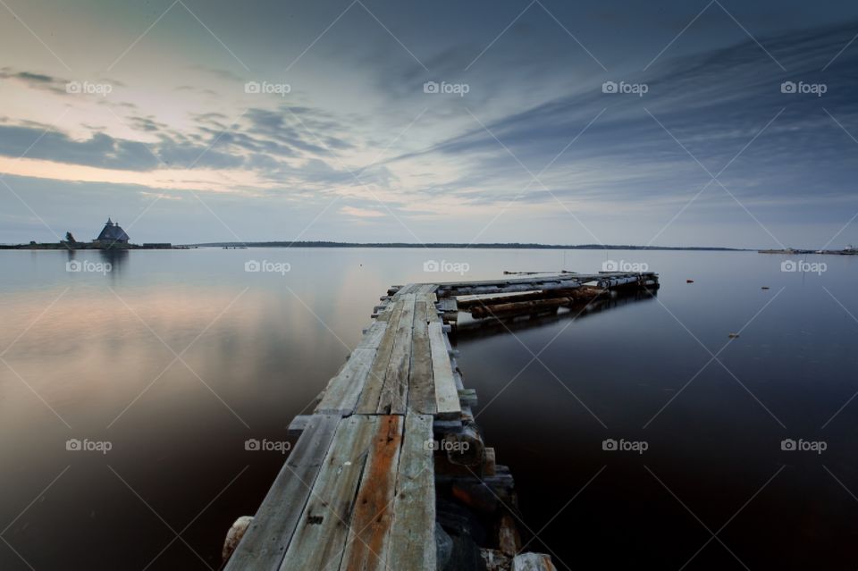 White Sea at early motning. Wooden church in Rabocheostrovsk, Kem, Russia