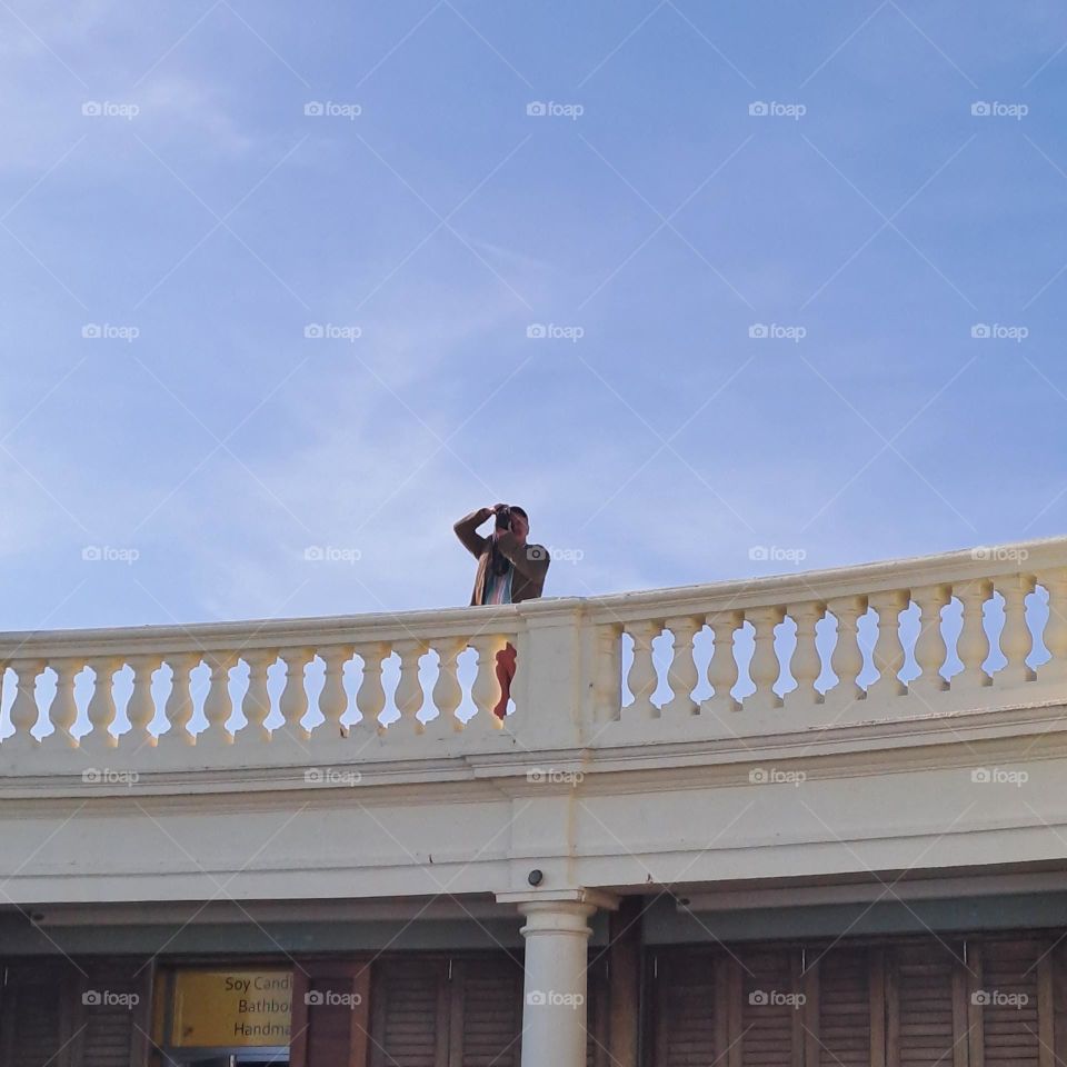 blue sky. photographer taking phot. camera blue sky