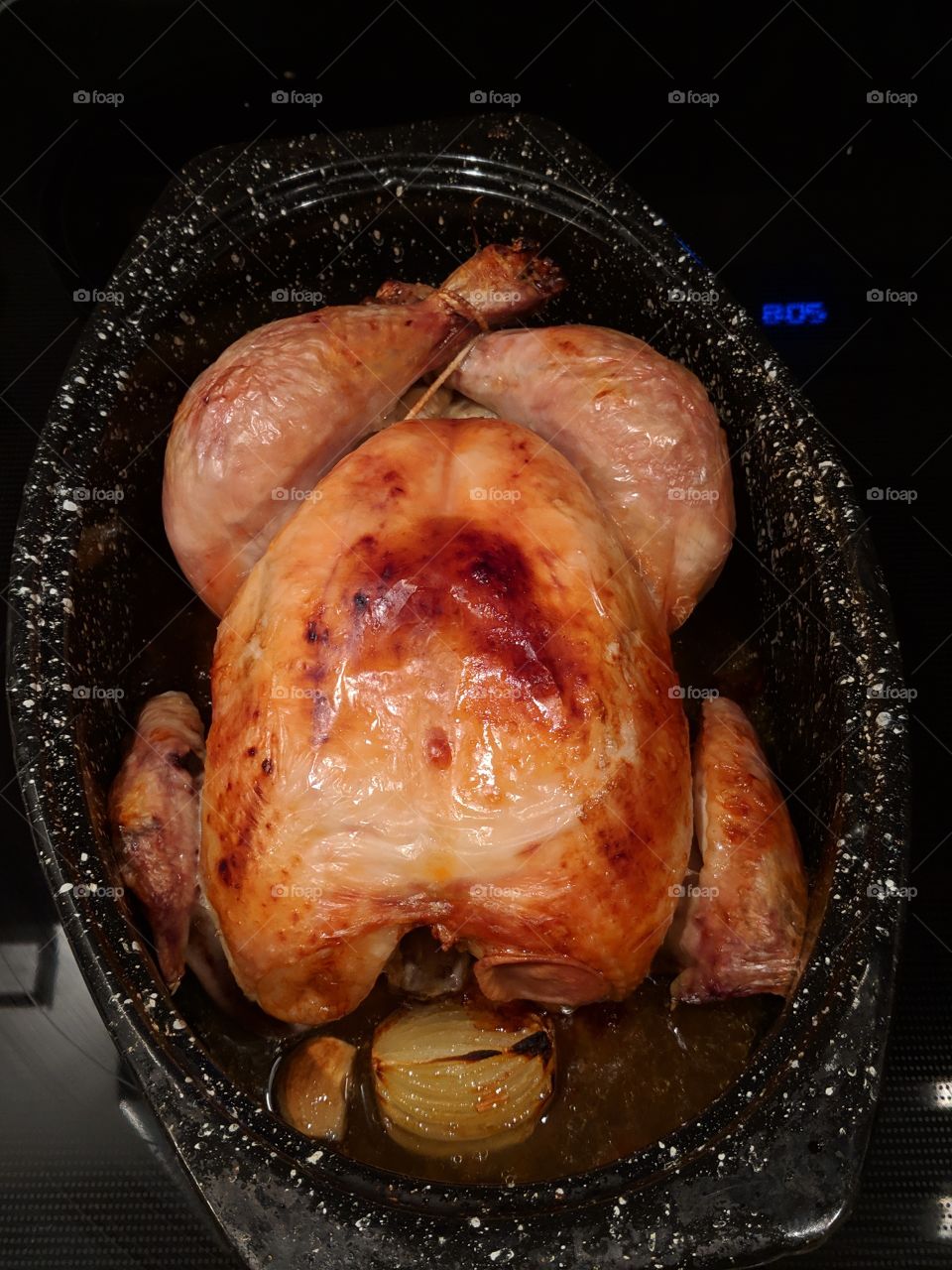 Perfectly roasted chicken with golden brown skin. Juicy chicken in roasting pan. cooked to perfection