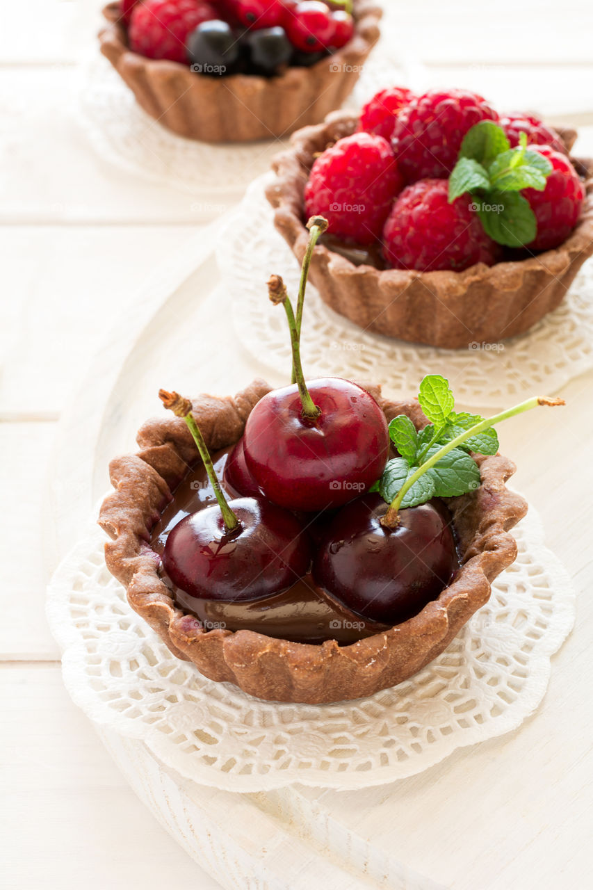 Homemade chocolate mini tarts with berries