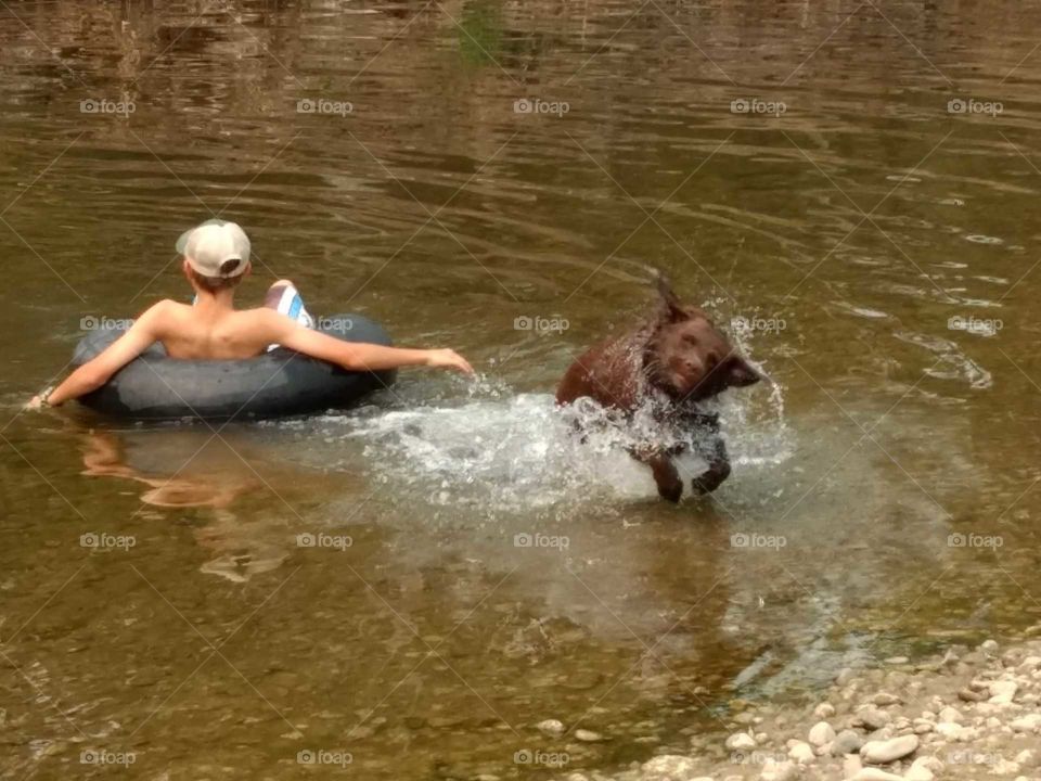 friends playing at the river
