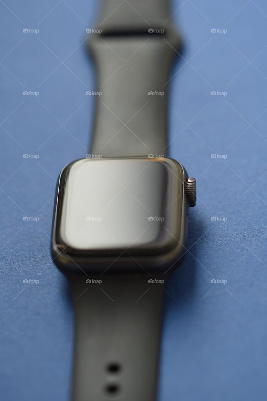 Closeup of a smart watch on blue background 