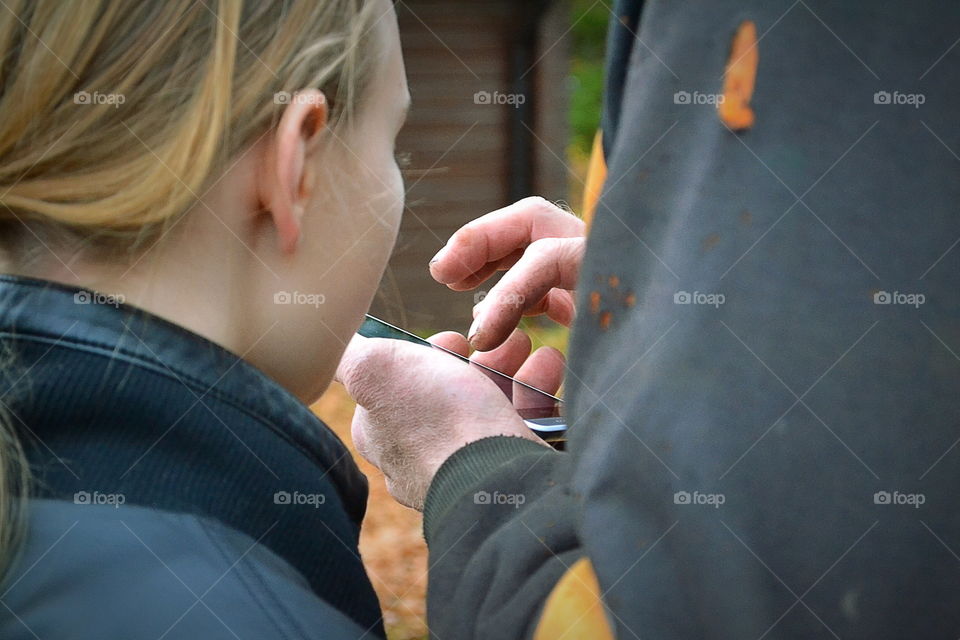 Two people looking at the phone