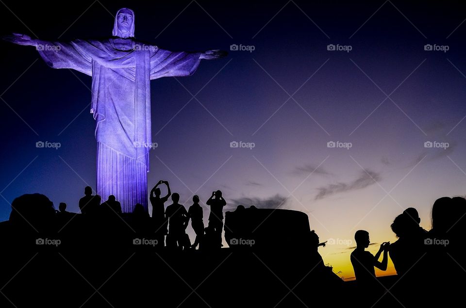 Tourists visit the Chris Redeemer at sunset in Rio de Janeiro