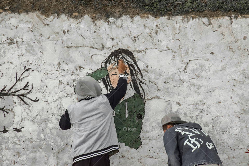 Neighborhood youth decorating community area street...