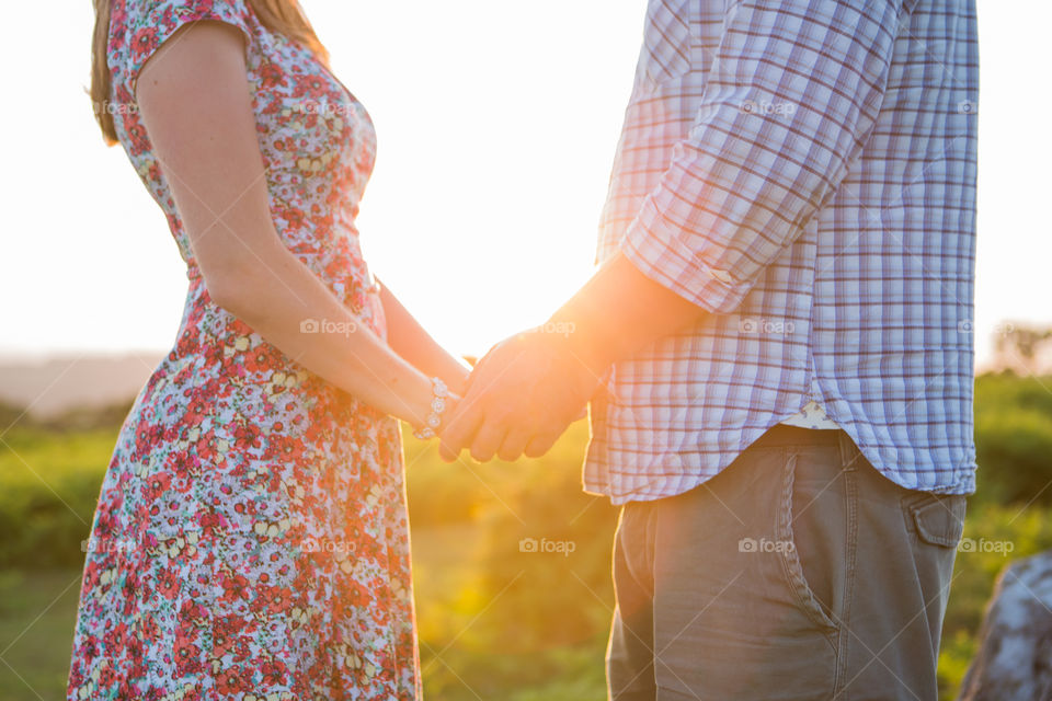 Hands in the sun. A couple in love hold hands in the sun