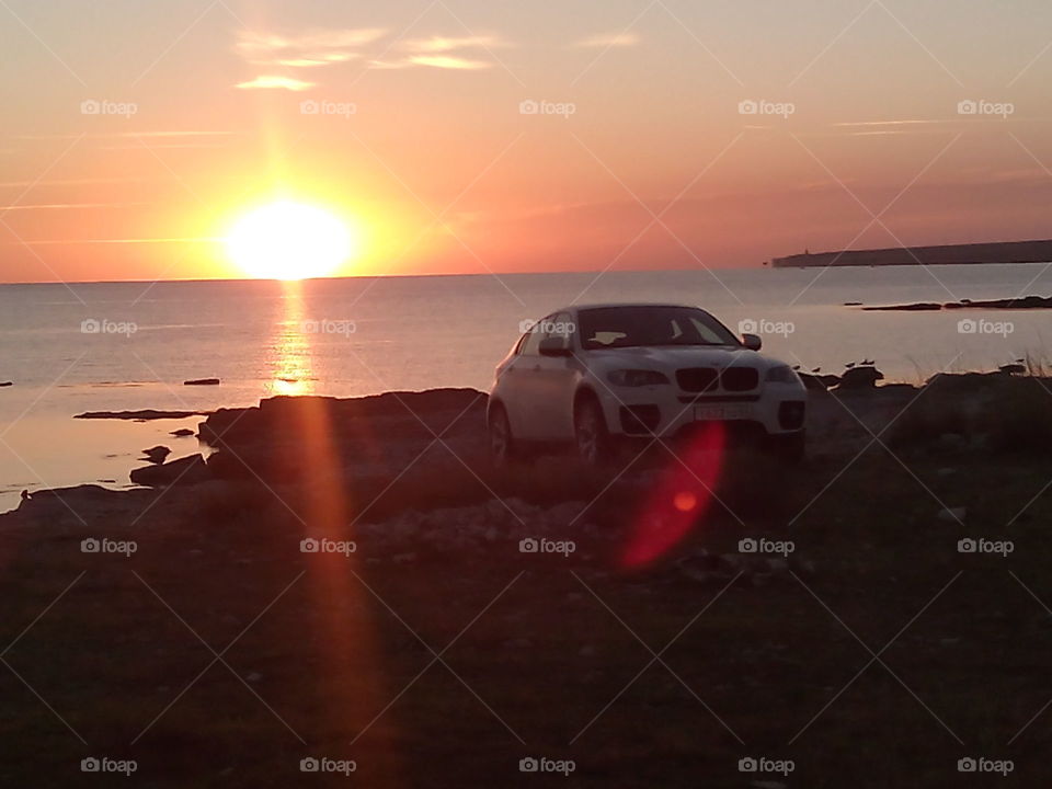 car on the sea sunset