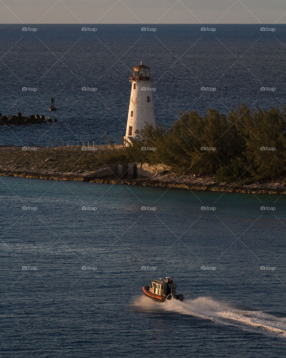 Lighthouse and boat. Bahamas.