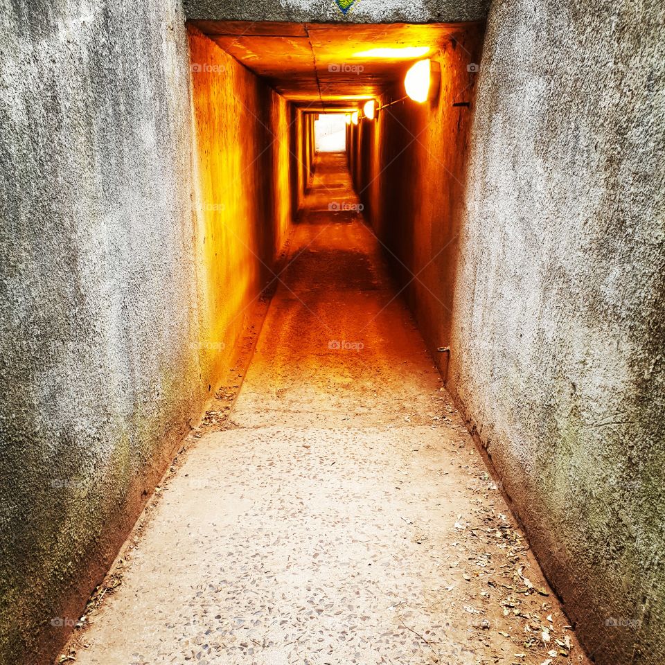 An old eerie lighted subway seems to provide a portal to another world.