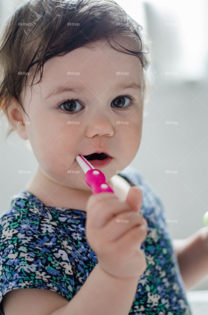 Baby girl brushing her teeth