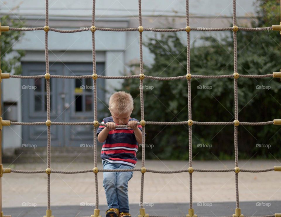 Toddler boy playing at the playground.