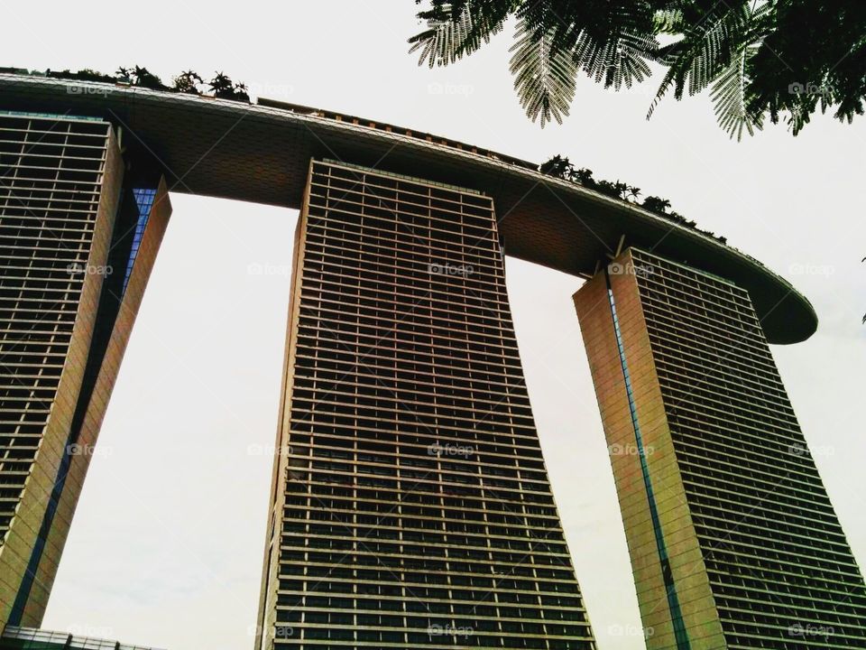 The Marina Bay Sands in Singapore looks over all those below it, reminding them to strive for a life filled with joy and comfort.