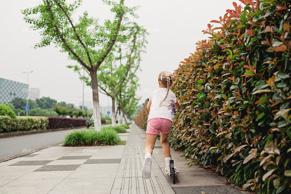 Girl riding on scooter 