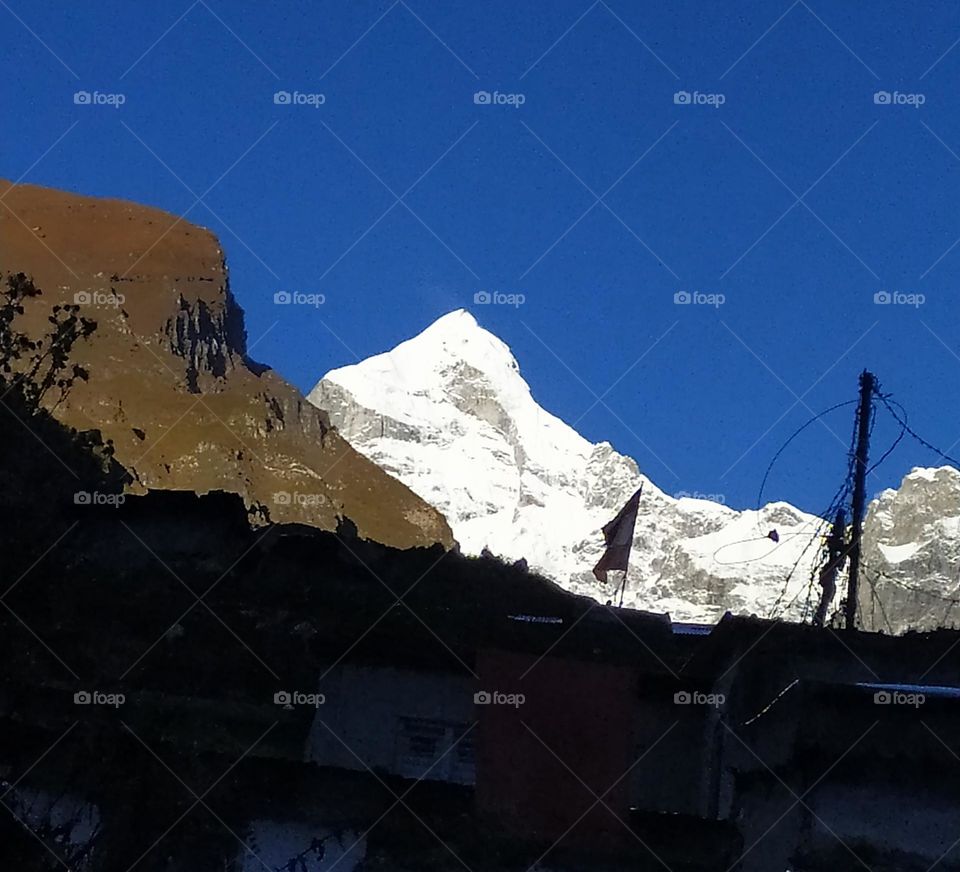 On a vacation in the Himalayas. Morning view of the magnificent Neelkanth peak from Badrinath