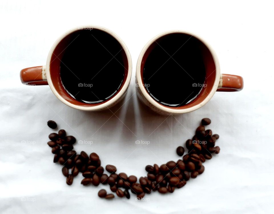 Smiling emoticon made of coffee beans