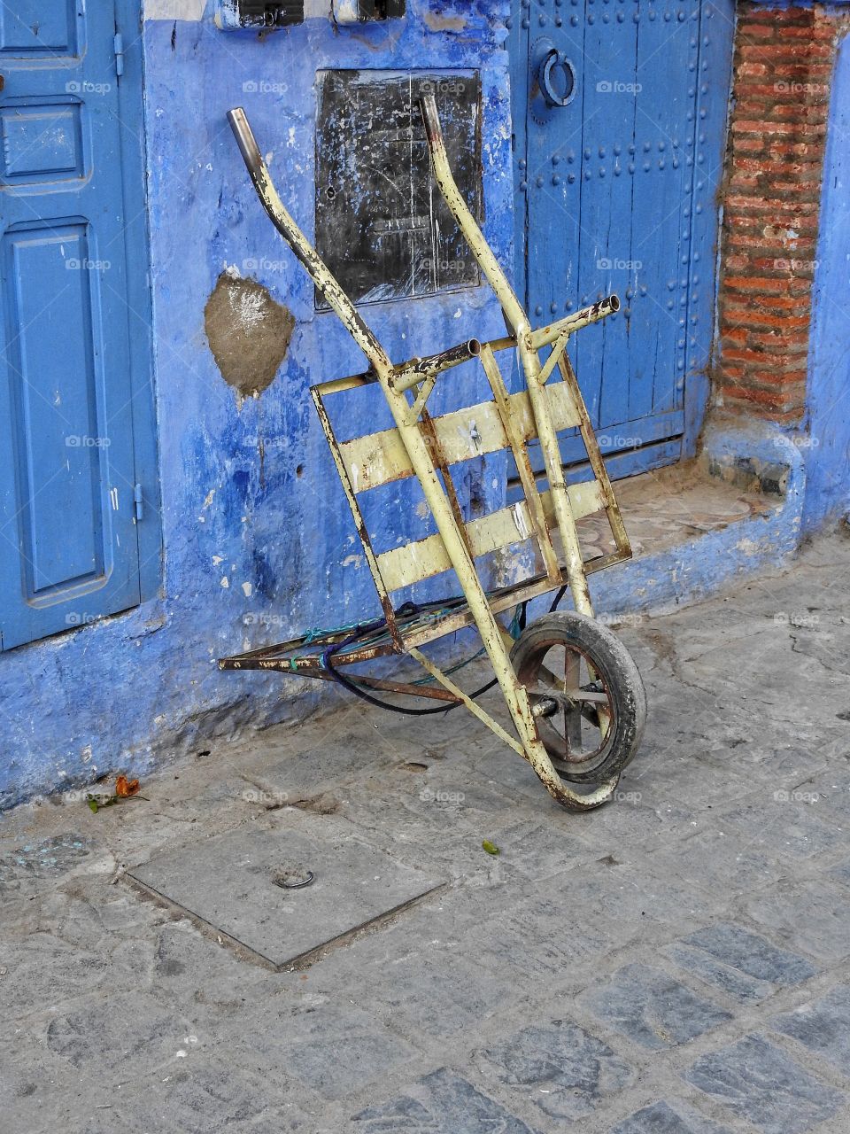 Wheelbarrow against wall