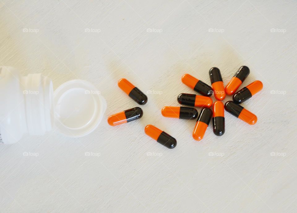 vitamins capsules colour on a white top view background