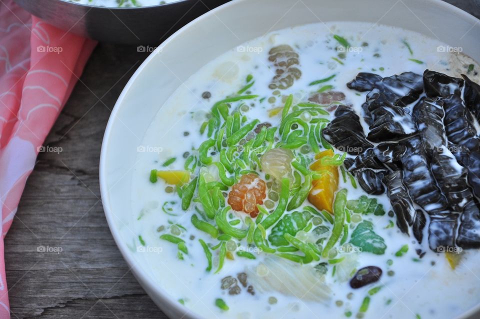 Thai iced dessert with cendol, grass jellies and potato in syrups in coconut milk.