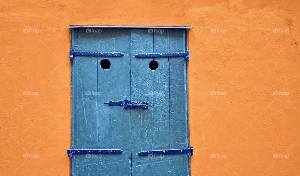 Photo of a blue door and an orange wall