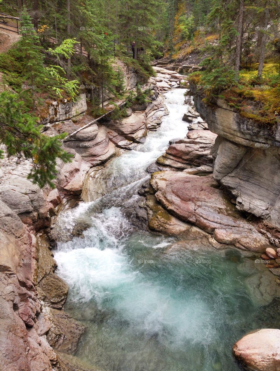 View of stream flowing through rocks