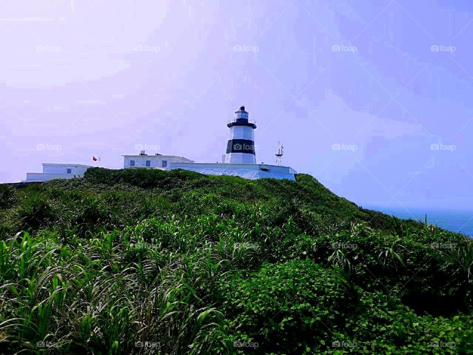 somewhere in the seashore hast this stoning view of a light house.