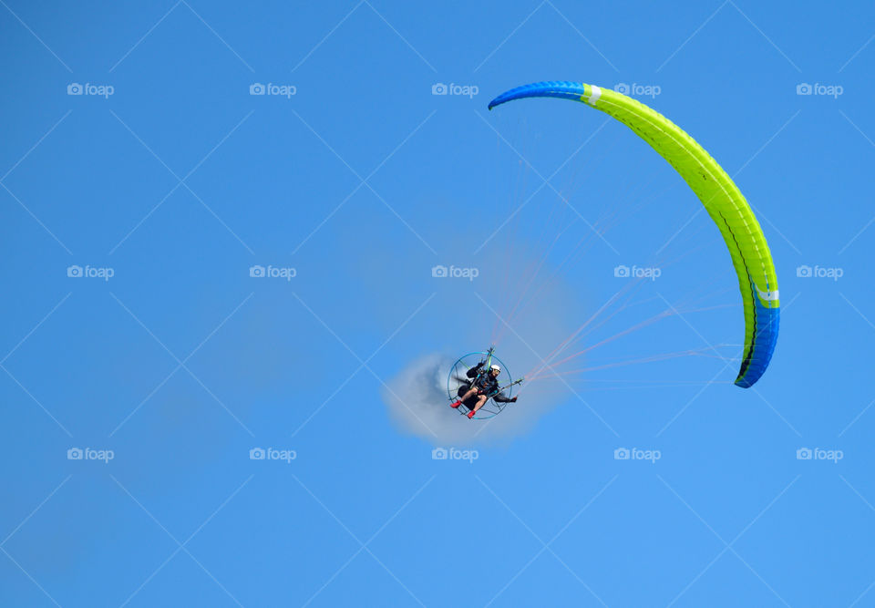 Helsinki, Finland - 9 June 2017: Unidentified pilot performing aerobatics stunts with a paramotor in the Kaivopuisto Air Show 2017 on sunny summer evening in Helsinki, Finland.