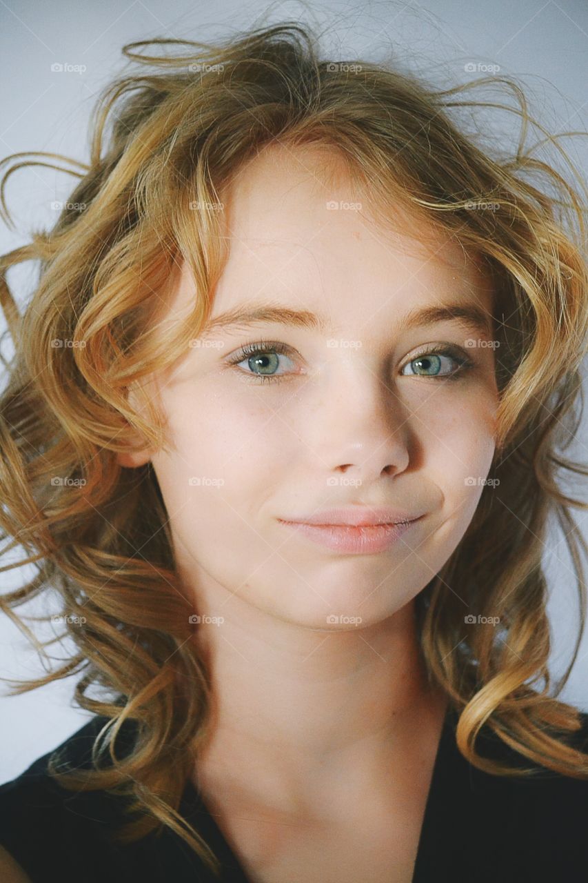 Smiling girl in curly hair