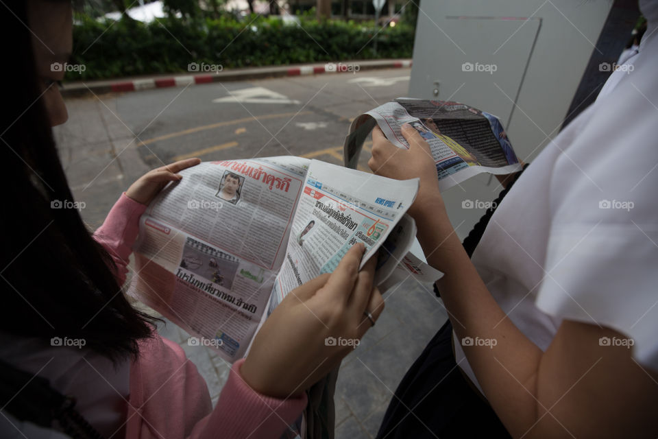 Girl reading newspapers 