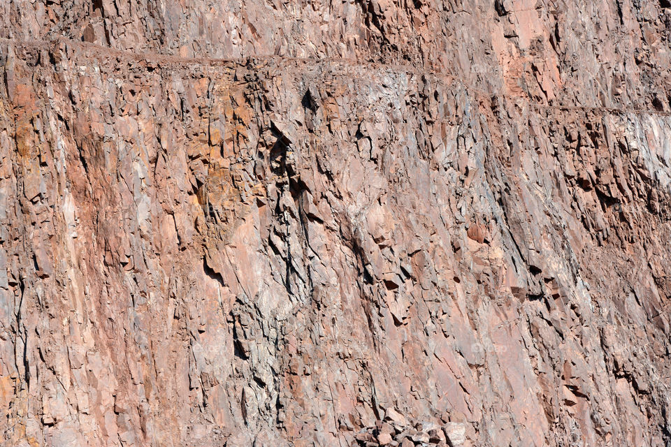 rock wall of porphyry rocks. mining industry. full frame background