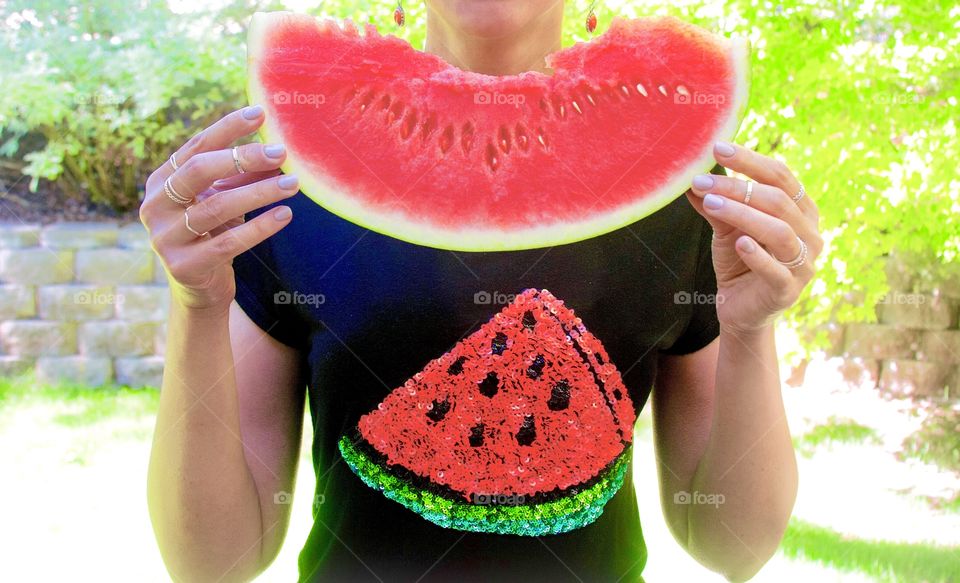 A slice of juicy watermelon in hands