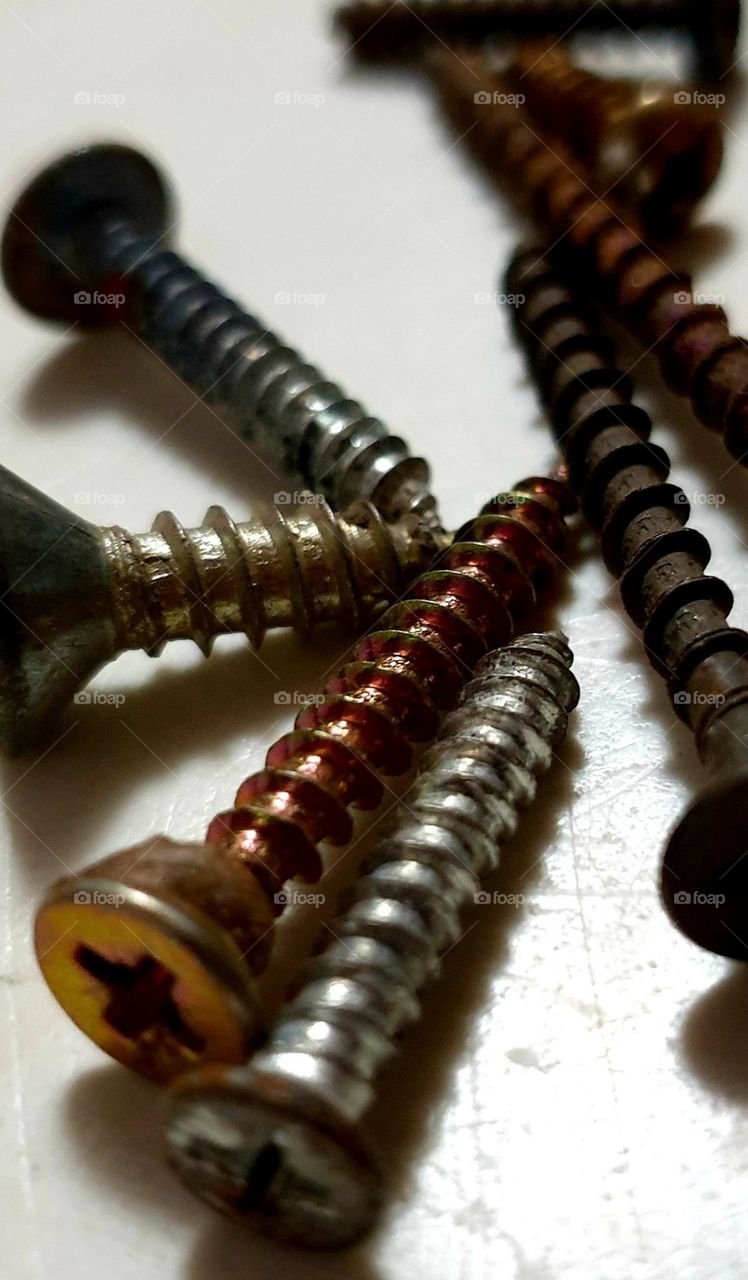 screws of various sizes and colors, some oxidized giving beautiful color and design